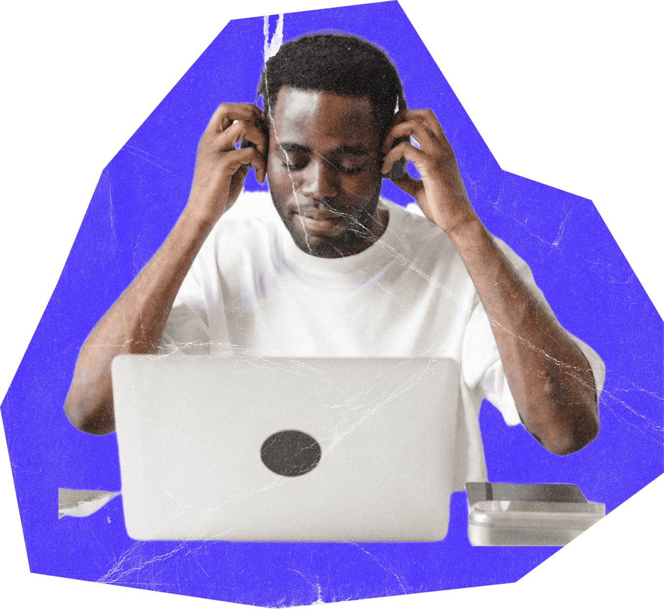 Student listening to headphones while using a laptop
